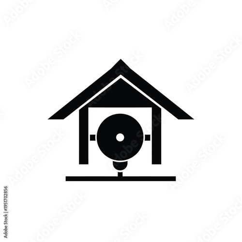 Black and white of a house with a bell inside