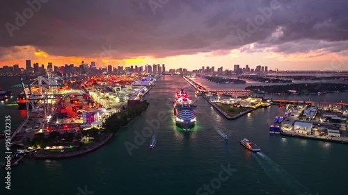 luxury cruising. Cruise ship tour and travel at sea. Cruise ship leaving Miami illuminated port. cruise ship voyage at night. cruise line. Miami port.