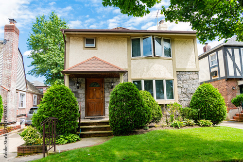 Property in neighborhood. Residential neighborhood house in developed area. Property insurance and real estate. Suburban neighborhood. Private property house. House insurance. Modern suburb