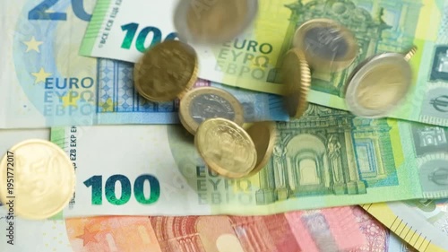 Euro Cent Coins Falling on Euro Banknotes Background Slow Motion