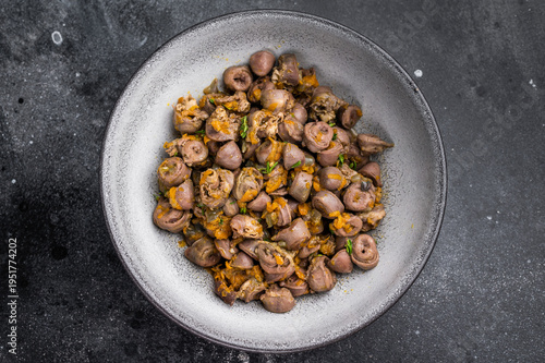 Canvastavla Tasty giblets stew served in gray plate on textured black surface ideal for culinary blogs or traditional meal visuals