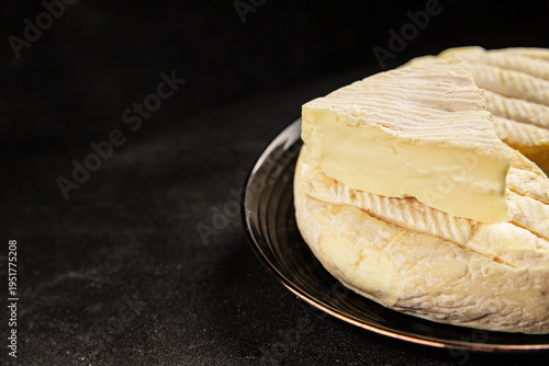 Soft cheese Camembert, Brie, or Coulommiers cheese head tasty snack fresh gourmet food background on the table rustic food top view copy space marketing concept photo