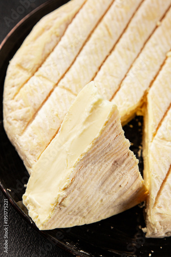 Soft cheese Camembert, Brie, or Coulommiers cheese head tasty snack fresh gourmet food background on the table rustic food top view copy space marketing concept photo