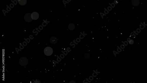 Floating white particles and bokeh dust move slowly across a dark background creating an ethereal effect