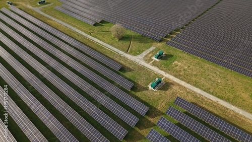 Bild auf Leinwand Aerial drone view of solar panels and green BESS battery storage units in a rura