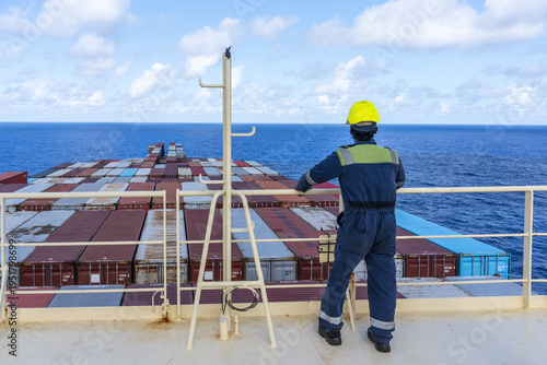 Foto Marine mechanic on board of a commercial shipping vessel, global transport concept