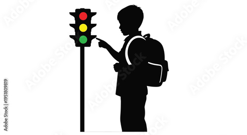Silhouette of a boy pointing at a traffic light with all lights illuminated