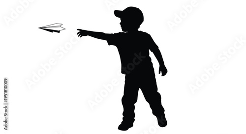 Silhouette of a boy reaching for a paper airplane in flight