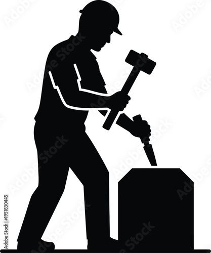Silhouette of a worker using a jackhammer on a concrete block