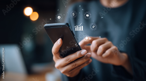 young entrepreneur using smartphone showing fintech payment interface with financial data icons.