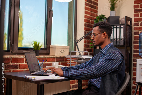 Fotografía Office worker researching company data on laptop, analyzing startup information for business growth