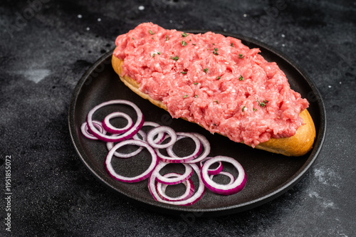 Tableau sur toile Raw beef cannibal sandwich with minced beef and red onion served on bread roll o