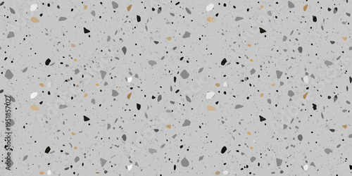 A gray terrazzo pattern with scattered dark and golden flecks