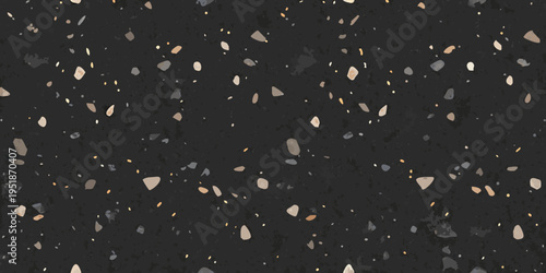 Dark speckled surface with scattered small stones and granular texture