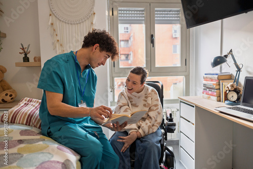 Obraz na płótnie Caregiver reading book to happy disabled woman