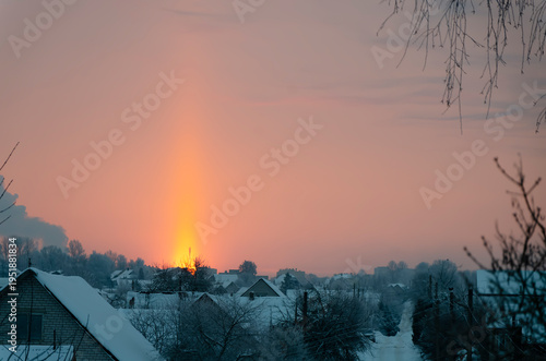 Fotografie A light pillar is a rare natural phenomenon that can be observed in extreme cold