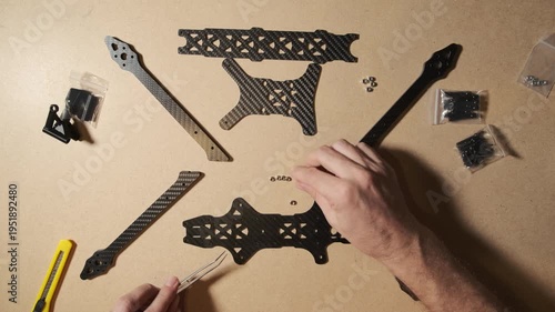 FPV drone quadcopter frame assembly at home. Modern weapon crafted by an enthusiast volunteer in Ukraine.