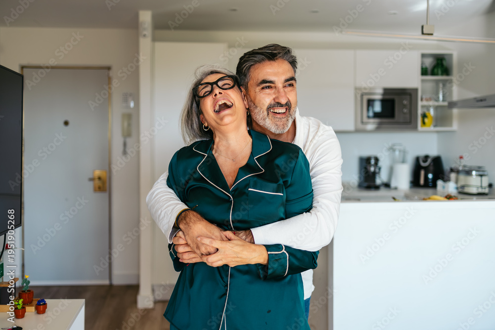 Fototapeta premium Mature couple dancing and laughing, embracing happiness