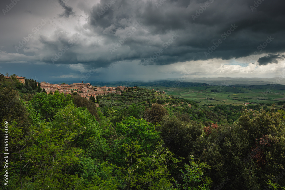 Fototapeta premium The historic town of Montalcino perched on a hill, famous for its Brunello wine. Classic Italian architecture surrounded by vineyards and the golden light of the Mediterranean.
