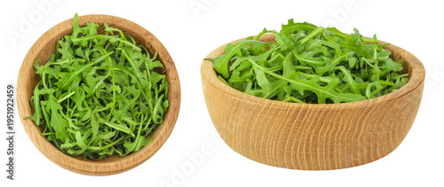 Heap of green fresh rucola or arugula leaf in wooden bowl isolated on white background. Top view, flat lay