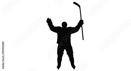 Celebrating hockey player with raised stick and arms a dramatic silhouette