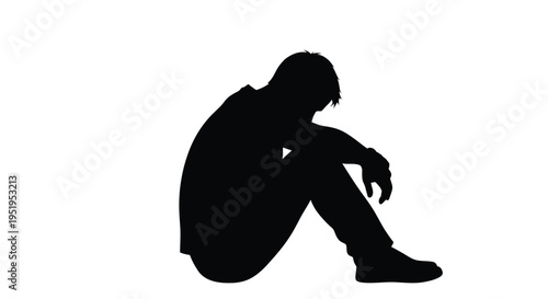 A solitary figure sits in contemplation a dark striking silhouette