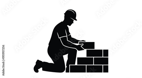 Black silhouette of a construction worker building a brick wall