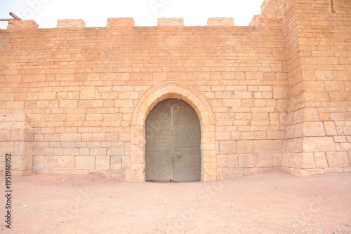 Ancient Fortress Gate at Atlas Film Studios, Ouarzazate, Morocco.
This image captures a majestic stone gateway set within a fortified wall, showcasing the iconic architectural style often seen in hist