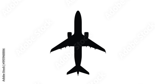 Overhead view of a passenger airplane in dark silhouette