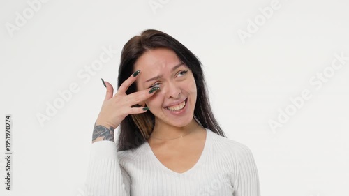 A young adult woman laughs cheerfully and contentedly white background isolated space