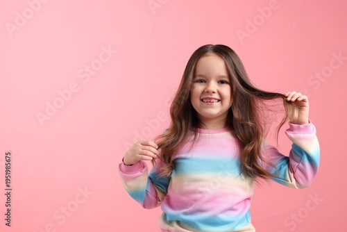 Quadro su tela Portrait of little girl on pink background. Space for text