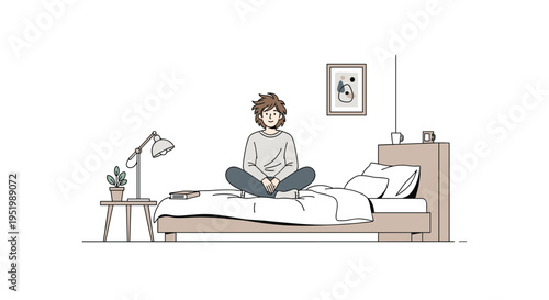 A person with short brown hair is sitting cross-legged on a bed next to a bedside table with a lamp and plant.