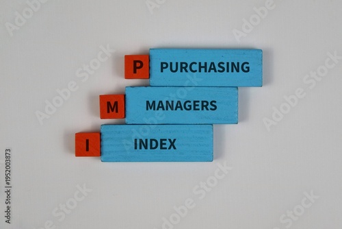 Wooden blocks spell out Purchasing Managers Index (PMI) on a white background, symbolizing business performance, economic indicators, market analysis.