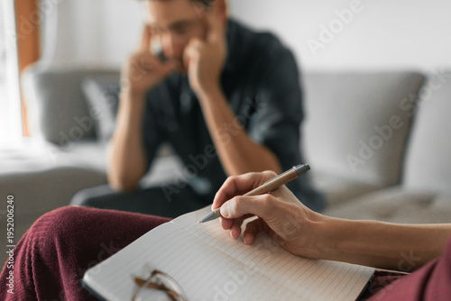 Tableau sur toile Couples therapy counseling session with therapist taking notes while stressed ma