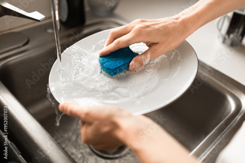 Принти на полотні Washing dishes in kitchen sink with sponge, daily routine and home cleaning conc