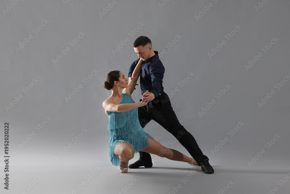 Obraz premium Couple of professional dancers on grey background