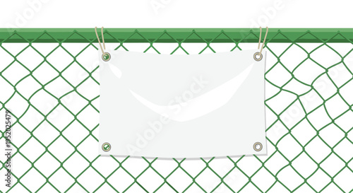 A blank, rectangular white banner with grommets and ropes is hanging on a green chain-link fence.