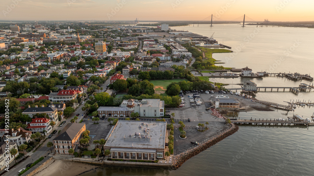 Naklejka premium Aerial view of waterfront landscapes in Charleston, South Carolina cityscape with historic buildings and ports with Arthur Ravenal Jr. Bridge 