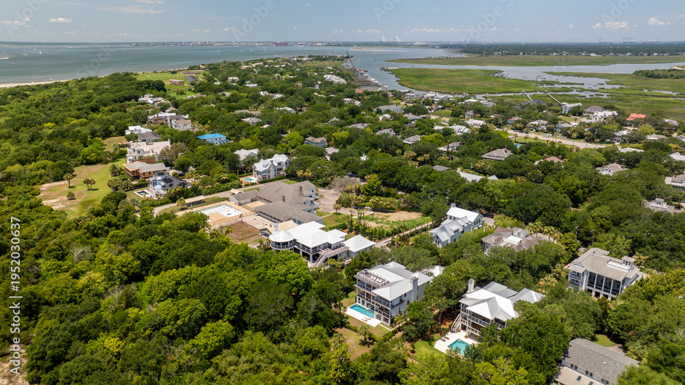 Fototapeta premium Aerial view shows landscapes of Sullivan's Island near Charleston, South Carolina featuring homes and greenery in the lowcountry area