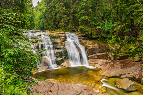 Close-up of cascading water over granite rocks in Riesengebirge forest