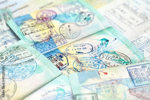 Obraz na płótnie Many open passport pages with lots of visas and entrance stamps from various countries passport control