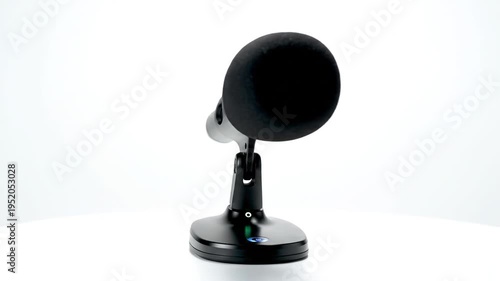 Close up studio microphone on adjustable stand with foam windscreen.