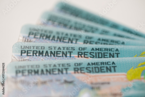 United States Permanent Resident cards stacked together. Concept of immigration, residency status, identity documentation, and legal authorization to live and work in the USA.