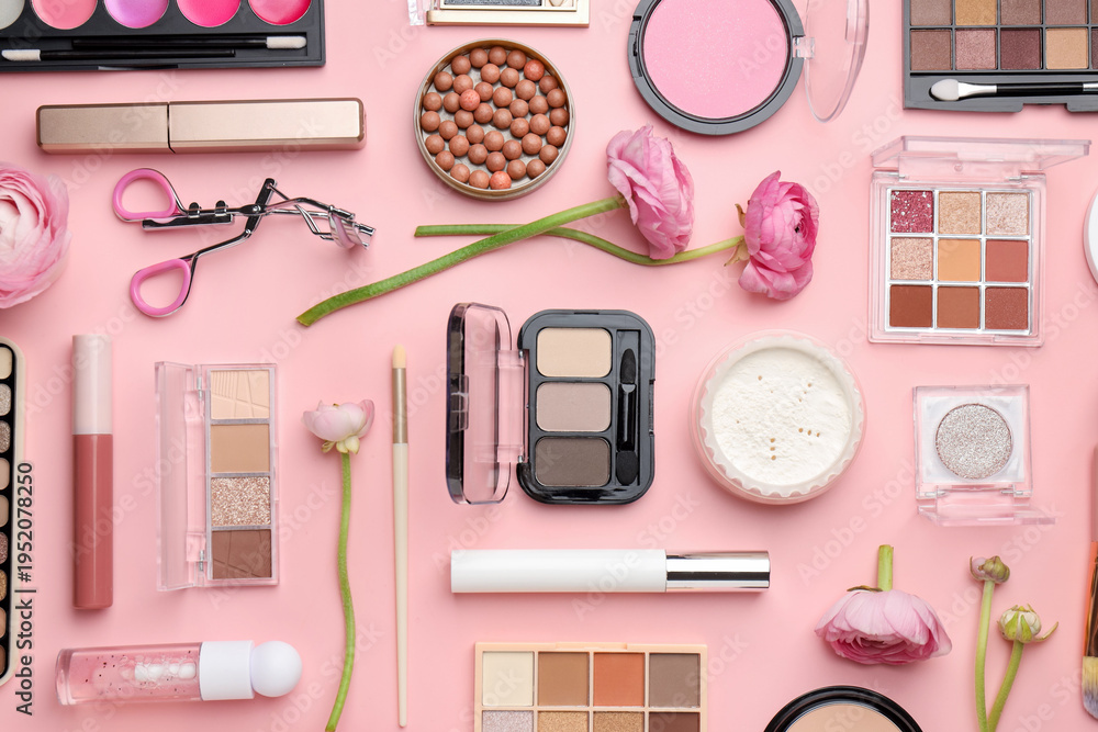 Fototapeta premium Spring composition with different makeup products and flowers on pink background, flat lay