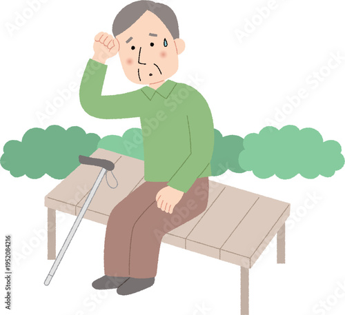 散歩中に疲れてベンチで休む高齢男性