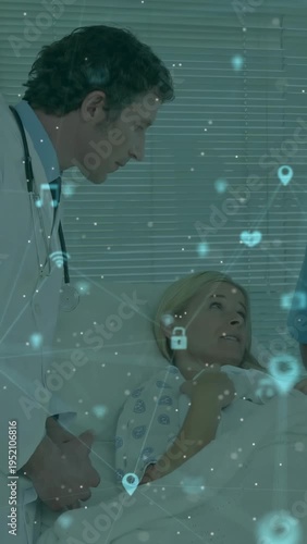 Physician leaning over patient, starting exam and projecting health icons over bed, patient smiling