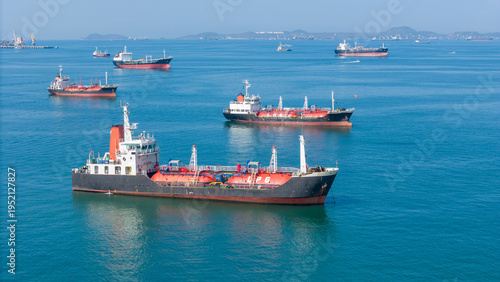 LPG gas and oil tanker ships anchored in the blue ocean. Industrial maritime transport, global energy logistics, and fossil fuel import export trade concept.