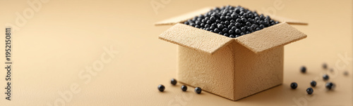 Abundant Black Beans Displayed: A cardboard box overflows with a generous pile of black beans, with a few scattered around, showcasing the healthy and nutritious qualities of this versatile food.