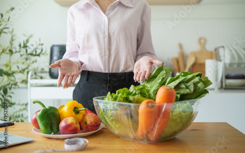 Nutritionist presenting fresh vegetables and fruits during healthy eating consultation. Healthy lifestyle and nutrition concept.