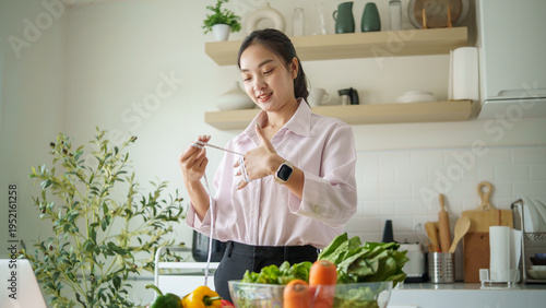 Diet planning and weight management concept, female nutritionist using measuring tape and fresh vegetables during online coaching session.